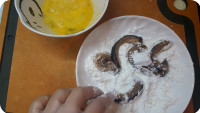 將花菇圍圈剪出螺旋型粗條，切成小段，再用廚紙吸乾水份，將花菇沾上鷹粟粉。
