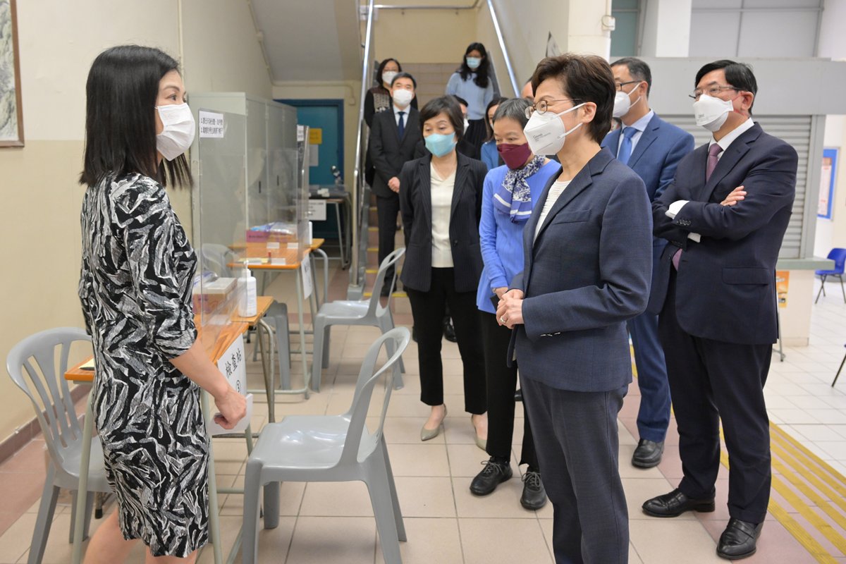 控制風險:  林鄭月娥（右三）聽取金文泰中學校長黎妙儀（左一）介紹校方在文憑試期間的防疫安排。
