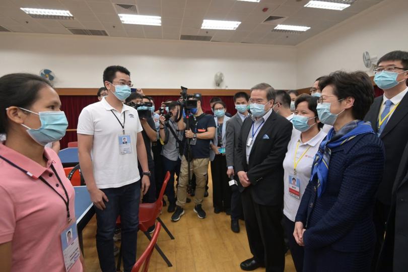 幕後功臣:  林鄭月娥（右二）與實驗室檢測人員交談。