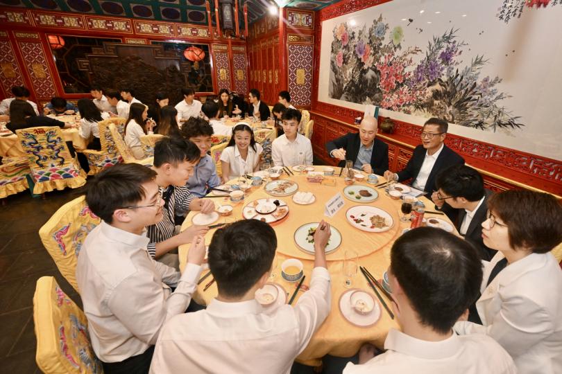 歡暢同坐: 陳茂波(右三)在北京與正在當地金融機構實習的香港大學生餐敍。 歡暢同坐: 陳茂波(右三)在北京與正在當地金融機構實習的香港大學生餐敍。