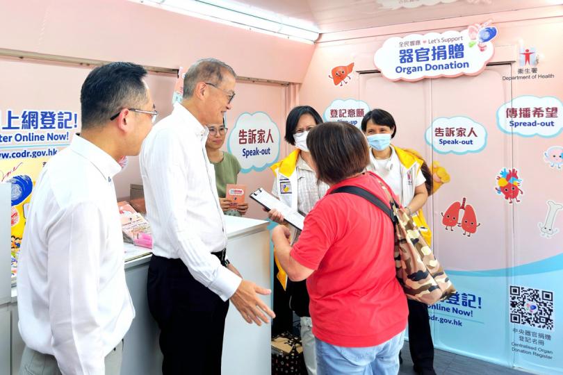 踴躍支持:  盧寵茂（左二）和林文健（左一）在宣傳車上協助市民即場在中央器官捐贈登記名冊登記。