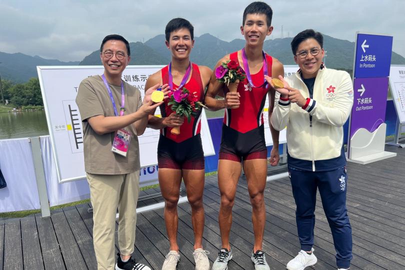 先拔頭籌: 楊潤雄(左)恭賀賽艇運動員林新棟(左二)和王瑋駿(右二)在杭州亞運會男子雙人單槳賽奪金。 先拔頭籌: 楊潤雄(左)恭賀賽艇運動員林新棟(左二)和王瑋駿(右二)在杭州亞運會男子雙人單槳賽奪金。
