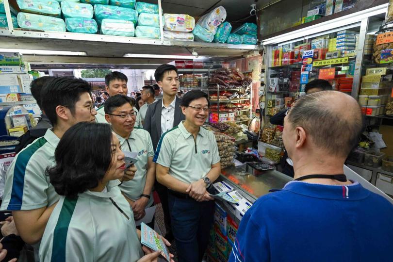關心民生:  李家超（前排右一）到訪觀塘順利邨，並與商戶交流，了解他的日常生活和生意情況。