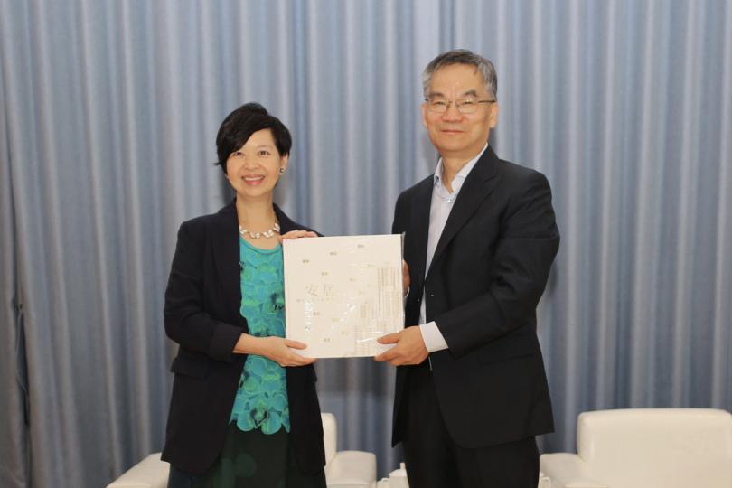 公營房屋:  何永賢（左）向曹金彪送贈房屋委員會50周年紀念特刊。