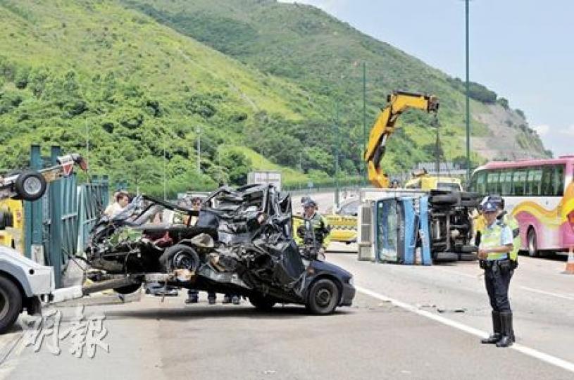 「拋錨」私家車被凍櫃貨車狂撼車尾,半截車身撞成廢鐵,貨車再滑行25米後翻側。私家車事後被拖走檢驗。(馮國良攝) 「拋錨」私家車被凍櫃貨車狂撼車尾,半截車身撞成廢鐵,貨車再滑行25米後翻側。私家車事後被拖走檢驗。(馮國良攝)