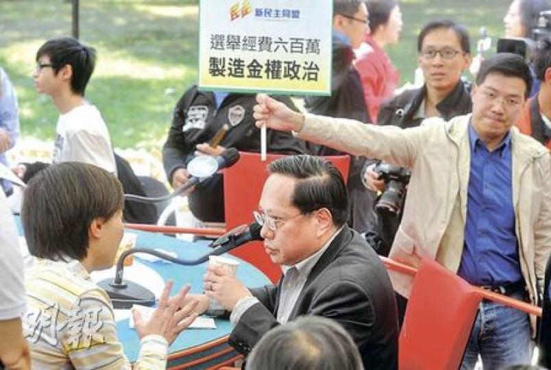 民主黨主席何俊仁(中)昨日出席《城市論壇》時,黨友、但已另起爐灶成立新民主同盟的范國威亦到場舉牌,抗議政改方案選舉經費過高。圖左一背向鏡頭者為政制及內地事務局副局長黃靜文。(尹錦恩攝) 民主黨主席何俊仁(中)昨日出席《城市論壇》時,黨友、但已另起爐灶成立新民主同盟的范國威亦到場舉牌,抗議政改方案選舉經費過高。圖左一背向鏡頭者為政制及內地事務局副局長黃靜文。(尹錦恩攝)