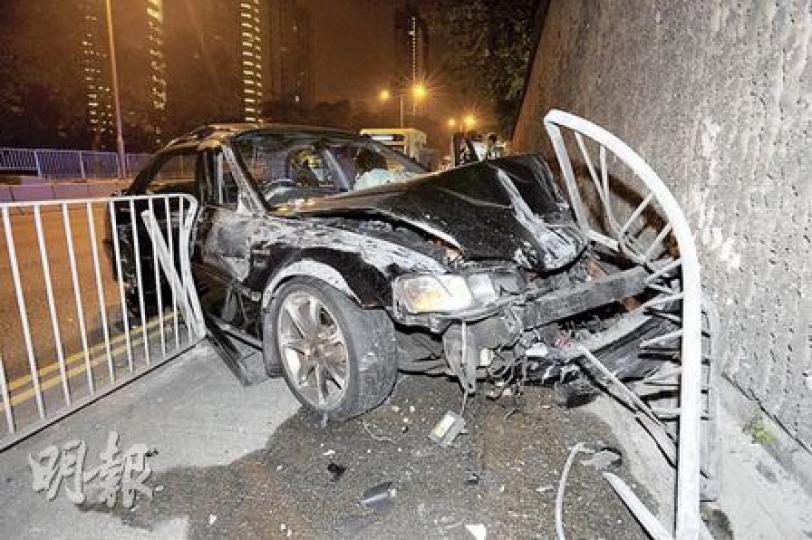 私家車失事撞欄衝上龍翔道行人路，車頭嚴重損毁。（樊銳昌攝）