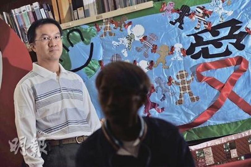義工Tim(左)及愛滋病人Eddie(右)一同製作的掛被,以藍色為主調,縫上手牽手的不同膚色人形布偶,比喻愛與關懷能掃除隔膜。(何家達攝) 義工Tim(左)及愛滋病人Eddie(右)一同製作的掛被,以藍色為主調,縫上手牽手的不同膚色人形布偶,比喻愛與關懷能掃除隔膜。(何家達攝)