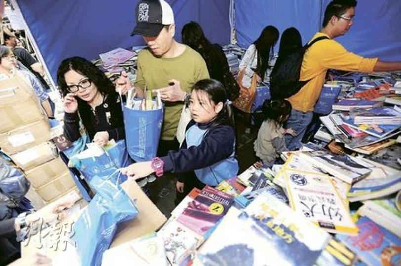 三聯書店在銅鑼灣街頭的書展，舉行「一百元一袋書」活動，黃先生一家三口「一人一袋」各自購得心頭好，開心地捧着戰利品回來，更大讚「非常抵買」。（朱永倫攝）