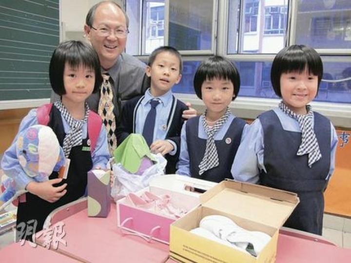 鮮魚行學校日前獲善長簡太及她3歲的兒子捐出1萬元，校長梁紀昌（左二）決定向每位學生派發50元資助過聖誕。（彭美芳攝）