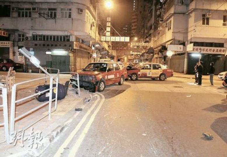 遭攔腰撞的士失控撞向路邊鐵欄及路牌，車禍中兩名女乘客輕傷。（蔡方山攝）