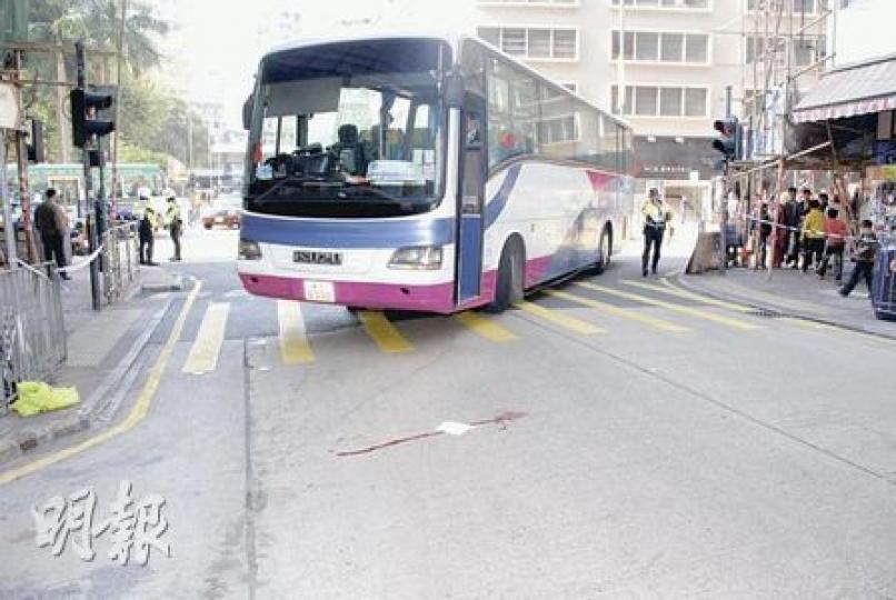 警員在浙江街旅遊巴撞傷老婦意外現場調查，地上遺下一灘血漬。（雲錦鋒攝）