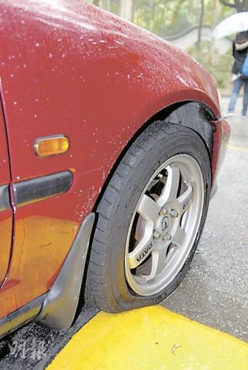屯門良景邨30部泊在路邊的車輛輪胎遭放氣,可看到被放氣的車胎明顯扁平。 (屈俊樂攝) 屯門良景邨30部泊在路邊的車輛輪胎遭放氣,可看到被放氣的車胎明顯扁平。 (屈俊樂攝)