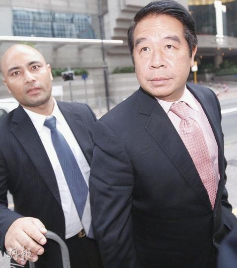 伯明翰班主楊家誠(右)昨獲批准離港赴英處理球會事務,他離庭時對記者左閃右避,其間更有攝影記者聲稱被楊的同行人士推倒。(李紹昌攝) 伯明翰班主楊家誠(右)昨獲批准離港赴英處理球會事務,他離庭時對記者左閃右避,其間更有攝影記者聲稱被楊的同行人士推倒。(李紹昌攝)