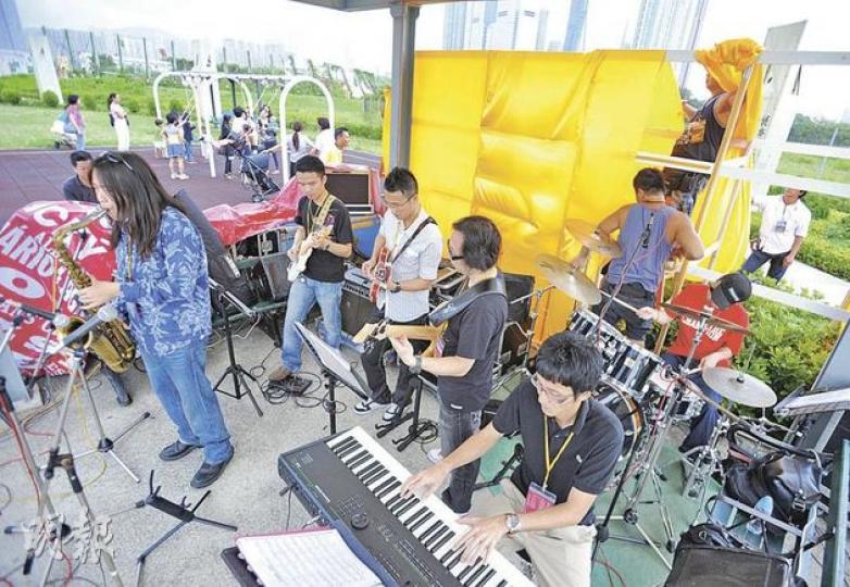 第4屆香港國際爵士音樂節上,有樂團不滿表演舞台是涼亭,樂隊Rum表演期間,工作人員只顧在後方架布幕,其間曾碰撞到鼓手(紅衫)。涼亭旁為兒童遊樂場,表演期間有不少小朋友正在蕩秋千。(李澤彤攝)香港國際爵士音樂節的壓軸音樂會昨日在西九舉行,「流動舞台」設在西九海濱長廊旁邊涼亭,欣賞演出的市民散落在通道上,「Hi-Tone」不滿大會不尊重而罷演,昨日另有兩隊樂隊演出。(李澤彤攝)「Hi-Tone」成員古馳(右)與Yanki(左)昨原定出席在西九的表演,認為不受尊重拒絕演出。古馳曾為歌手陳奕迅《六月飛霜 第4屆香港國際爵士音樂節上,有樂團不滿表演舞台是涼亭,樂隊Rum表演期間,工作人員只顧在後方架布幕,其間曾碰撞到鼓手(紅衫)。涼亭旁為兒童遊樂場,表演期間有不少小朋友正在蕩秋千。(李澤彤攝)香港國際爵士音樂節的壓軸音樂會昨日在西九舉行,「流動舞台」設在西九海濱長廊旁邊涼亭,欣賞演出的市民散落在通道上,「Hi-Tone」不滿大會不尊重而罷演,昨日另有兩隊樂隊演出。(李澤彤攝)「Hi-Tone」成員古馳(右)與Yanki(左)昨原定出席在西九的表演,認為不受尊重拒絕演出。古馳曾為歌手陳奕迅《六月飛霜