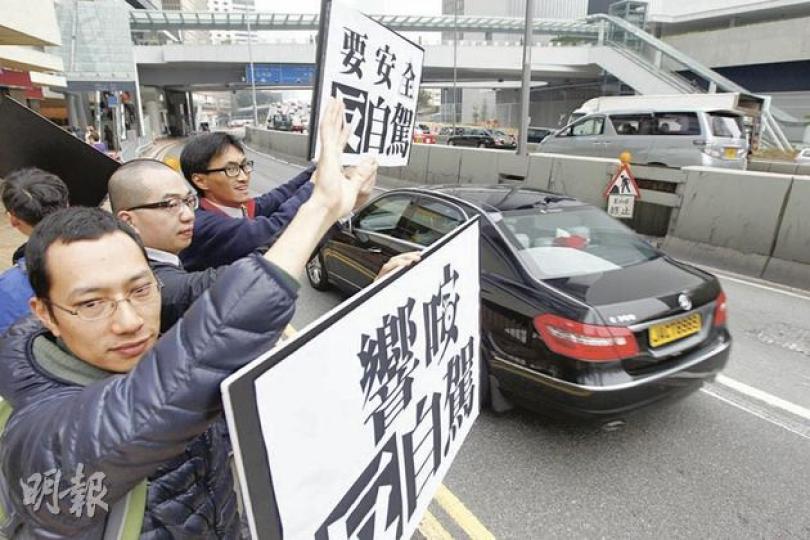 約10名反對自駕遊的示威者昨日於政府總部對出馬路舉起「反自駕」標語,要求政府擱置跨境自駕遊計劃,部分路過車輛即響號響應。(李紹昌攝) 約10名反對自駕遊的示威者昨日於政府總部對出馬路舉起「反自駕」標語,要求政府擱置跨境自駕遊計劃,部分路過車輛即響號響應。(李紹昌攝)