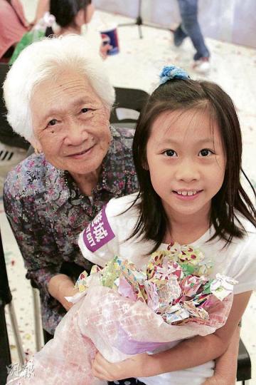 梁太﹙左﹚含辛茹苦養育的10名子女均已出身,其孫女﹙右﹚趁母親節親手用彩紙摺出花朵,送贈婆婆。(鄭宏禮攝) 梁太﹙左﹚含辛茹苦養育的10名子女均已出身,其孫女﹙右﹚趁母親節親手用彩紙摺出花朵,送贈婆婆。(鄭宏禮攝)
