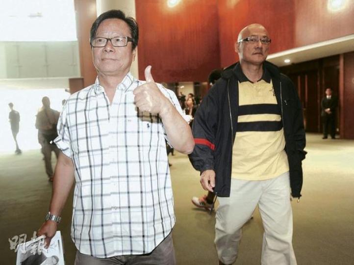 人民力量黃毓民（左）得知政府押後改組議案後，做出勝利手勢，但他拒評「拉布」是否成功。右為人民力量陳偉業。（余俊亮攝）
