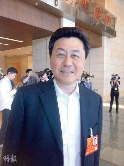 李剛笑容滿面，但記者提到香港事務，李剛話自己已調走，唔會評論嘞。（黃振豪攝）