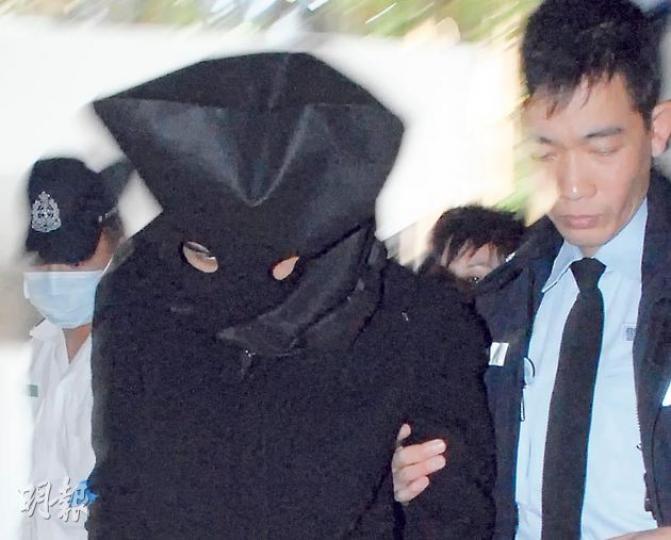 涉嫌收錢向他人淋鏹的15歲少年，昨日在警方押解下蒙着頭到醫院求醫。（雲錦鋒攝）