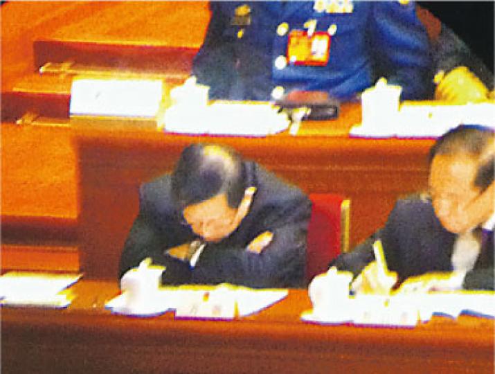 坐於主席台一角的全國政協副主席萬鋼（左）在聽報告時似在打瞌睡。（明報記者攝）