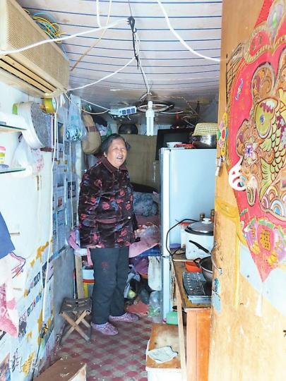 來自河南信陽的64歲董大媽和老伴租住在化石營村僅50呎的簡易房中，雖然冬冷夏特也要每月800元租金，這也花去了他們每月僅1000元左右生活費的大部分。（明報記者攝）李克強報告中指，「決不能一邊高樓林立，一邊棚戶連片」，但北京周邊卻有大大小小的「貧民區」近50個。圖為化石營村。（明報記者攝）