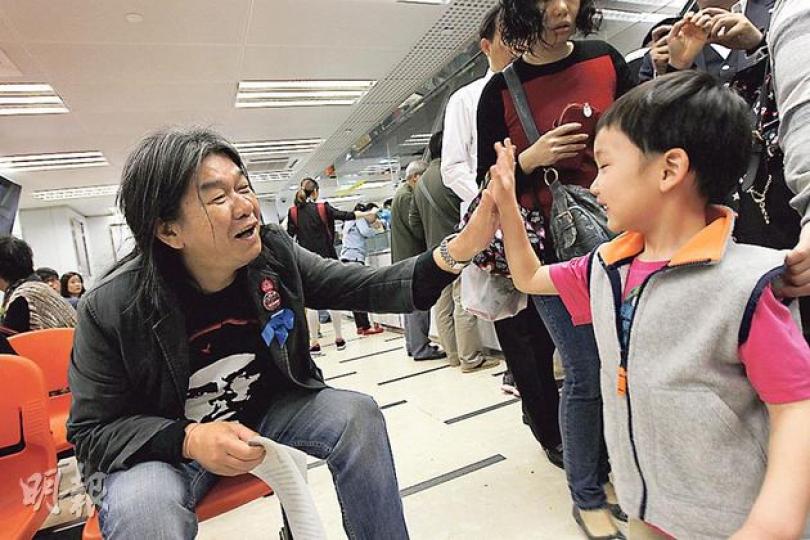 長毛（左）去中旅社申請回鄉證，其間唔少人見到長毛喺呢度現身都覺得出奇，有人上前影相，更有小朋友同長毛擊掌，希望長毛去上海一路順風啦！（李紹昌攝）