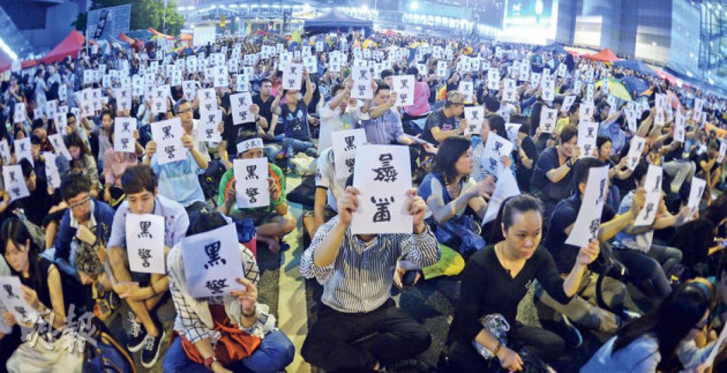 佔中行動今天踏入第19天,因昨凌晨爆出警員涉濫用私刑事件,昨晚大批市民重新聚集在金鐘夏愨道集會,大會向市民派發「黑警」紙牌,呼籲市民一齊高舉和倒轉,要求警方拘捕7名涉事警員。(劉焌陶攝) 佔中行動今天踏入第19天,因昨凌晨爆出警員涉濫用私刑事件,昨晚大批市民重新聚集在金鐘夏愨道集會,大會向市民派發「黑警」紙牌,呼籲市民一齊高舉和倒轉,要求警方拘捕7名涉事警員。(劉焌陶攝)