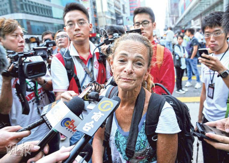 戰地女記者Paula Bronstein前晚涉嫌刑事毁壞被警方拘捕通宵扣查,昨晨獲保釋後即返回旺角佔領現場繼續工作。(蔡方山攝)Paula Bronstein報稱因現場太多人才站上平治跑車車頭冚自保,房車司機譚先生(箭嘴示)聲稱當時曾多次要求她下來不果,才向警員求助。(余俊亮攝) 戰地女記者Paula Bronstein前晚涉嫌刑事毁壞被警方拘捕通宵扣查,昨晨獲保釋後即返回旺角佔領現場繼續工作。(蔡方山攝)Paula Bronstein報稱因現場太多人才站上平治跑車車頭冚自保,房車司機譚先生(箭嘴示)聲稱當時曾多次要求她下來不果,才向警員求助。(余俊亮攝)