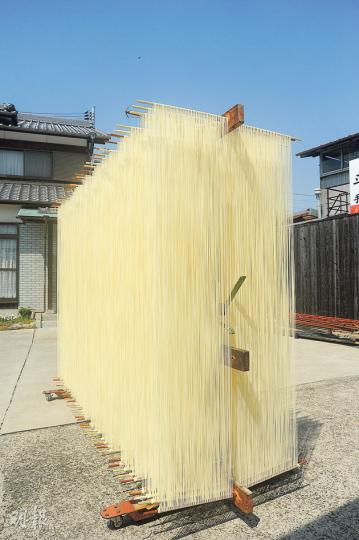 完成延長和鬆開互相黏連麵線的工序後，素麵便連麵帶架推到室外曬半天。（水京攝）麵條在拉長後還要經過撥鬆的工序，訪客會獲邀體驗親手製作手延素麵。（水京攝）館內展廳擺放着各種生產醬油的傳統器具。（水京攝）醬油味軟雪糕是必吃之選。（水京攝）醬油就是在這個泳池般深的木桶內發酵而成。（水京攝）公園裏的圓錐形風車，已成為小豆島的地標之一。（水京攝）坐在小豆島高處，整個橄欖公園，以至大小外島的明媚風光盡收眼簾。（黃若萍攝）（明報製圖）