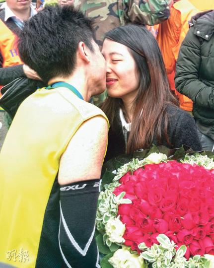 昨日渣馬出現溫馨場面,跑手劉先生以4小時完成全馬賽事後,與友人「夾計」,手持玫瑰花、氣球及戒指,向相識5年的女友盧小姐求婚,最終抱得美人歸。在現場記者起哄下, 兩人深情一吻。(林婉斐攝) 昨日渣馬出現溫馨場面,跑手劉先生以4小時完成全馬賽事後,與友人「夾計」,手持玫瑰花、氣球及戒指,向相識5年的女友盧小姐求婚,最終抱得美人歸。在現場記者起哄下, 兩人深情一吻。(林婉斐攝)