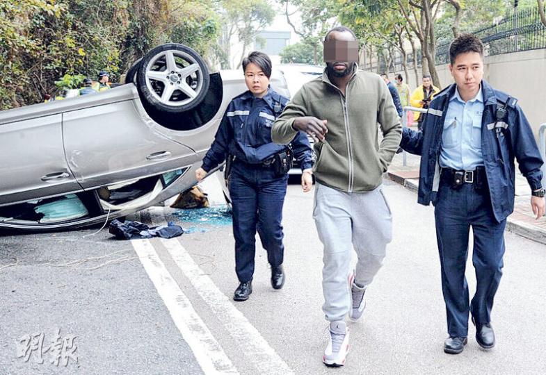 岡比亞籍男子(中)到車禍現場報稱是乘客,但被目擊者「踢爆」是司機,他經酒精呼氣測試後證實超標,與企圖頂包的尼日利亞男子同被捕。(衛永康攝) 岡比亞籍男子(中)到車禍現場報稱是乘客,但被目擊者「踢爆」是司機,他經酒精呼氣測試後證實超標,與企圖頂包的尼日利亞男子同被捕。(衛永康攝)