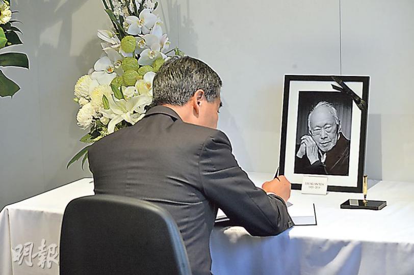 特首梁振英昨到新加坡駐港總領事館簽署弔唁冊,離開時領事館職員一度把守門口,不讓記者追訪梁振英;記者想拍攝梁寫上的字句,職員亦將弔唁冊蓋上。(葉家豪攝) 特首梁振英昨到新加坡駐港總領事館簽署弔唁冊,離開時領事館職員一度把守門口,不讓記者追訪梁振英;記者想拍攝梁寫上的字句,職員亦將弔唁冊蓋上。(葉家豪攝)