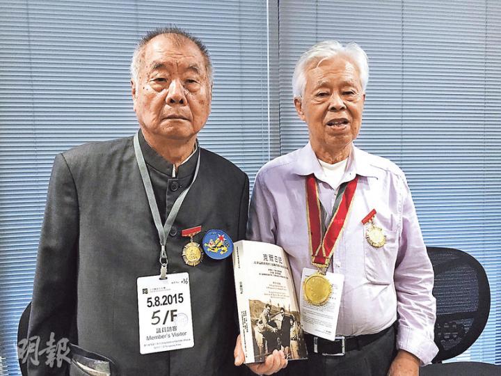 克爾留港期間，當年只得十多歲的東江縱隊港九獨立大隊隊員黃立光（左），和海上中隊戰士羅競輝（右），昨日亦有出席記者會。羅手中所持為新書《克爾日記》。（陳洛明攝）