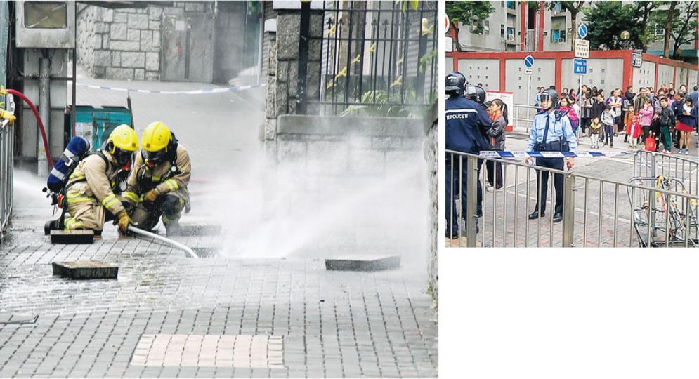 花園大廈孔雀樓對開牛頭角道昨發生地底渠道爆炸事故，消防員趕至向沙井射水，起火及爆炸原因有待調查。警方封鎖現場及疏散孔雀樓底座數十戶居民進行調查，現場一度聚集等候解封的市民。（林智傑攝）