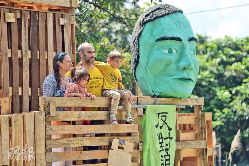 粉嶺馬屎埔有發展商收回土地時與留守的村民發生衝突。馬屎埔村民早前以卡板搭起高台以監察附近情况,並把綠色的「守田者」掛在高台上,寓意不讓壞人破壞農地。來自俄羅斯的Anna(左起)、兩歲女兒、丈夫、5歲兒子反對將農地作商業發展,加入一眾馬屎埔農夫,共同守護這片土地。(鄧宗弘攝)來自俄羅斯的Anna(中)認為人類需與大自然共生,她在橫額上寫上俄文,支持馬屎埔的農夫及反對地產商收地。(鄧宗弘攝) 粉嶺馬屎埔有發展商收回土地時與留守的村民發生衝突。馬屎埔村民早前以卡板搭起高台以監察附近情况,並把綠色的「守田者」掛在高台上,寓意不讓壞人破壞農地。來自俄羅斯的Anna(左起)、兩歲女兒、丈夫、5歲兒子反對將農地作商業發展,加入一眾馬屎埔農夫,共同守護這片土地。(鄧宗弘攝)來自俄羅斯的Anna(中)認為人類需與大自然共生,她在橫額上寫上俄文,支持馬屎埔的農夫及反對地產商收地。(鄧宗弘攝)