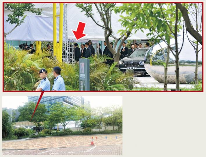 警方在沙田科學園設了兩個採訪區,其中一個設於浚湖樓近百米外電動車充電站,左圖為記者站於記者區內拍攝,肉眼難看到全國人大委員長張德江於白色帳篷進入大樓時情况。本報攝影記者在採訪區以200毫米的長焦距鏡頭,僅能拍攝到張德江(上圖,箭嘴示)的背影。(蘇智鑫、陳柔雅攝) 警方在沙田科學園設了兩個採訪區,其中一個設於浚湖樓近百米外電動車充電站,左圖為記者站於記者區內拍攝,肉眼難看到全國人大委員長張德江於白色帳篷進入大樓時情况。本報攝影記者在採訪區以200毫米的長焦距鏡頭,僅能拍攝到張德江(上圖,箭嘴示)的背影。(蘇智鑫、陳柔雅攝)