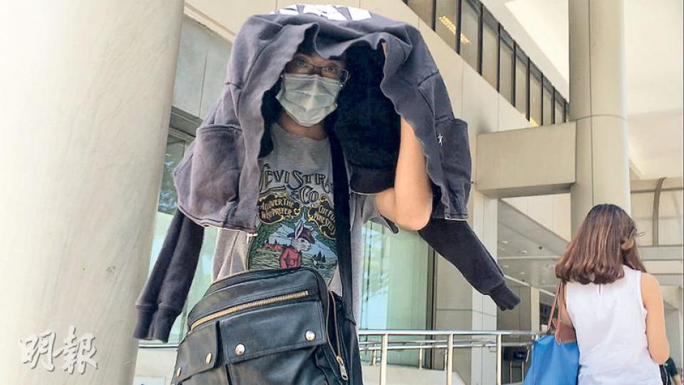 因恐嚇罪成被判12個月感化令的鄧志恒以黑色外套遮頭,戴上口罩離開東區裁判法院。(鄧可盈攝) 因恐嚇罪成被判12個月感化令的鄧志恒以黑色外套遮頭,戴上口罩離開東區裁判法院。(鄧可盈攝)