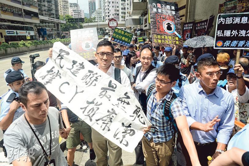 「全城捉鬼大聯盟」約40個示威者噚日去民主黨總部外示威,話林卓廷(前方白衣者)爆廉署內幕係「作古仔」。阿廷就拎住「民建聯最無恥 撑CY損廉潔」標語應戰,佢被示威者包圍,要由警員開路護送離場。(鍾林枝攝) 「全城捉鬼大聯盟」約40個示威者噚日去民主黨總部外示威,話林卓廷(前方白衣者)爆廉署內幕係「作古仔」。阿廷就拎住「民建聯最無恥 撑CY損廉潔」標語應戰,佢被示威者包圍,要由警員開路護送離場。(鍾林枝攝)