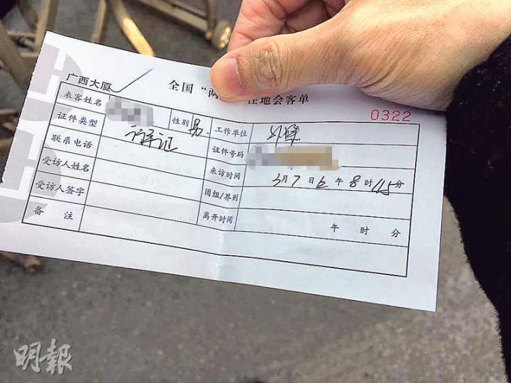 記者向櫃台人員交出行車證後,收到一張寫上簡單資料的「會客單」。(明報記者攝) 記者向櫃台人員交出行車證後,收到一張寫上簡單資料的「會客單」。(明報記者攝)