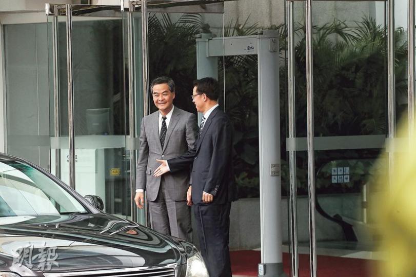 特首梁振英（左）昨拜訪中聯辦，中聯辦主任張曉明到門外親自迎接，更停留片刻讓門外傳媒拍照。他主動想與梁振英握手，不過梁未有察覺，當時正望向相反方向，令張曉明伸出的手懸空數秒，略顯尷尬（圖）；兩人會面約一個半小時後，張曉明送梁振英到大門口，並再次握手讓記者拍攝（圖2）。（李紹昌攝）（圖2）（李紹昌攝）