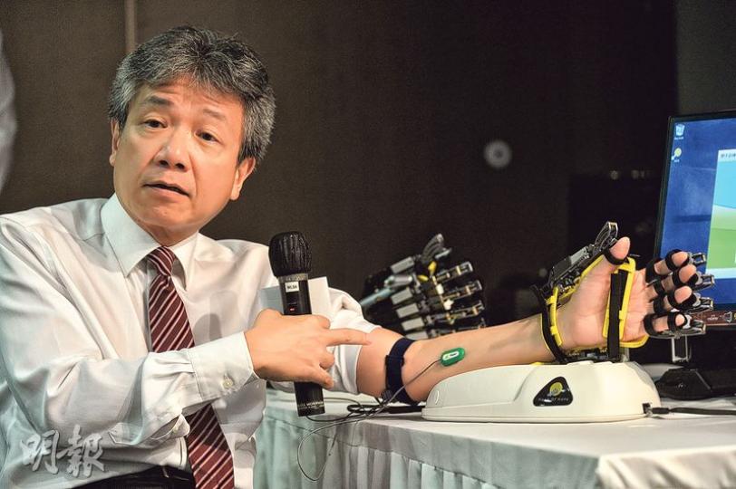 社創基金專責小組主席張仁良現場示範使用「希望之手」,該產品讀取患者皮膚表面的「肌電信號」,即其大腦郁動手掌的意識,從而幫助他伸展手掌,可輔助中風和其他腦損傷患者作手部復康訓練。(蘇智鑫攝) 社創基金專責小組主席張仁良現場示範使用「希望之手」,該產品讀取患者皮膚表面的「肌電信號」,即其大腦郁動手掌的意識,從而幫助他伸展手掌,可輔助中風和其他腦損傷患者作手部復康訓練。(蘇智鑫攝)