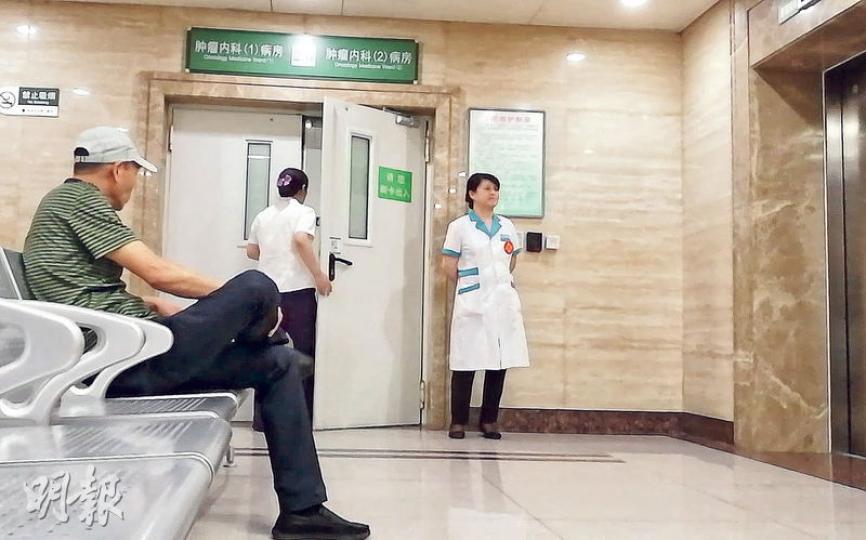 醫院腫瘤內科病房原本開放的兩個探視大門僅一個允許使用,但也全程緊閉,且有護工守衛。(明報記者攝) 醫院腫瘤內科病房原本開放的兩個探視大門僅一個允許使用,但也全程緊閉,且有護工守衛。(明報記者攝)