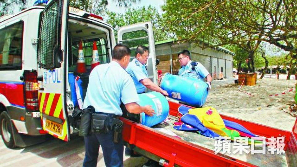 ■警方將3個膠桶抬走化驗。胡恩宏攝