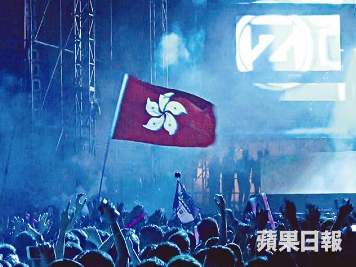 ■大批觀眾在場內隨歌起舞，有人高舉香港區旗。