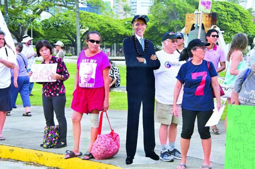 ■檀香山市中心有反特朗普示威,有人帶了「奧巴馬」助陣。 美聯社 ■檀香山市中心有反特朗普示威,有人帶了「奧巴馬」助陣。 美聯社