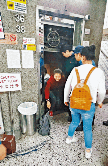 ■被困的內地旅客在消防員協助下爬出地面。讀者提供圖片