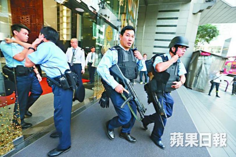 ■警方在中環站搜捕期間，有女子在警員前拍照留念。王子俊攝
