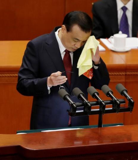 ■李克強在宣讀政府工作報告期間抹汗。路透社 ■李克強在宣讀政府工作報告期間抹汗。路透社