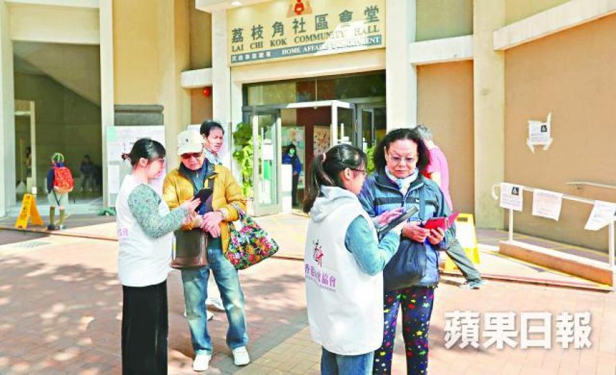 ■多名香港研究協會調查員在荔枝角社區會堂票站外訪問選民。謝榮耀攝 ■多名香港研究協會調查員在荔枝角社區會堂票站外訪問選民。謝榮耀攝